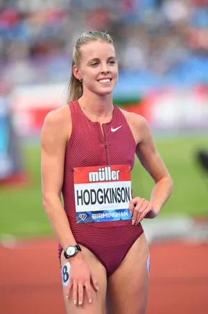 A Woman In A Red Bikini Standing On A Track Wallpaper