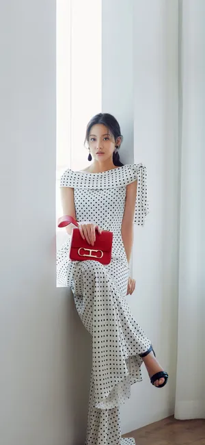 A Woman In A White Dress Leaning Against A Window Wallpaper
