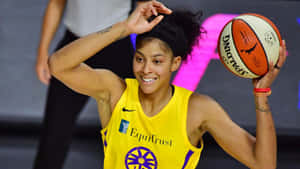 A Woman In A Yellow Uniform Holding A Basketball Wallpaper