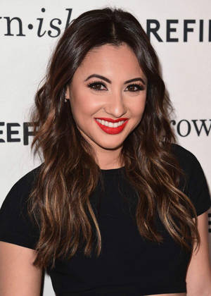 A Woman In Black With Red Lipstick Posing For A Photo Wallpaper