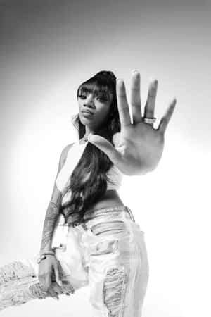 A Woman In Ripped Jeans And A Hand Out Wallpaper