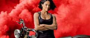 A Woman Is Standing On A Motorcycle With Her Arms Crossed Wallpaper