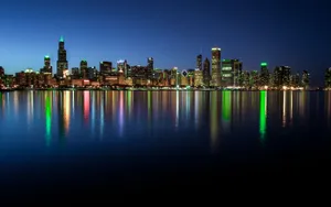A Woman Looking Out Of A Window With A View Of A City's Night Skyline Wallpaper