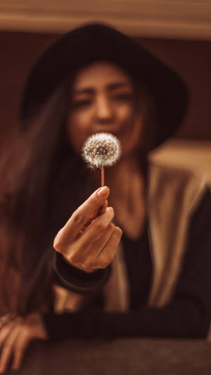 A Woman's Hand Delicately Holding A Pristine White Flower, Shot Against A Bokeh Background, Perfect For Your Iphone Wallpaper. Wallpaper