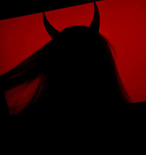 A Woman's Head Is Silhouetted Against A Red Background Wallpaper