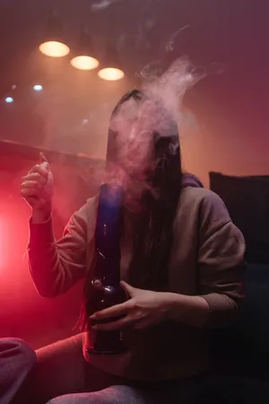 A Woman Smoking A Vaporizer In A Living Room Wallpaper