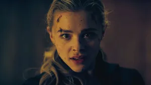 A Woman With A Bloody Face Looking At The Camera Wallpaper