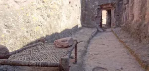 A Wooden Bed Frame Beside Lalibela's Rock-hewn Church Wallpaper