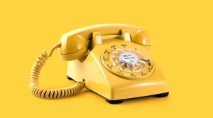 A Yellow Telephone On A Yellow Background Wallpaper