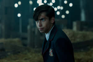 A Young Man In A School Uniform Standing In A Barn Wallpaper