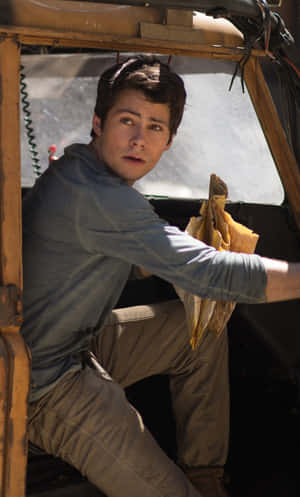 A Young Man Sitting In The Back Seat Of A Truck Wallpaper