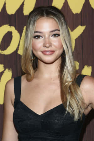 A Young Woman In A Black Dress Posing For A Photo Wallpaper