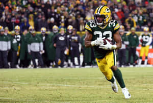 Aaron Jones Of The Green Bay Packers Demonstrates His Elite Skill In American Football. Wallpaper