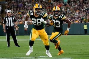 Aaron Jones Playing In A Green Bay Packers Game Wallpaper