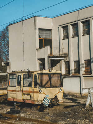 Abandoned_ Train_ Car_ Near_ Building Wallpaper