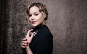 Abbie Cornish Posing Gracefully In A Serene Outdoor Setting Wallpaper