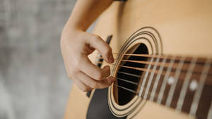 Acoustic Guitar Strumming The Strings Wallpaper