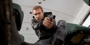 Action Hero Aiming Gun Wallpaper