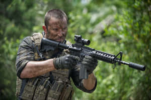 Action Ready Soldier In Jungle Environment Wallpaper