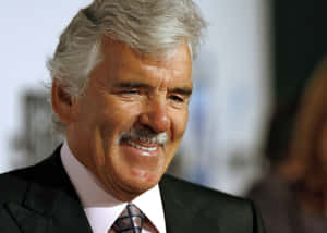 Actor Dennis Farina Posing In An Elegant Suit. Wallpaper