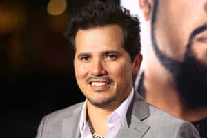 Actor John Leguizamo Looks Focused And Serious Wallpaper