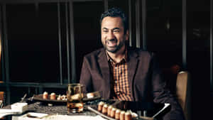 Actor Kal Penn Posing For A Photoshoot Wallpaper