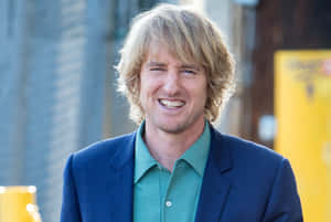 Actor Owen Wilson Strikes A Pose In A Crisp Blue Suit. Wallpaper