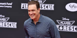 Actor Patrick Warburton Striking An Animated Pose Wallpaper