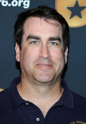 Actor Rob Riggle As He Looks Off Into The Horizon Wallpaper