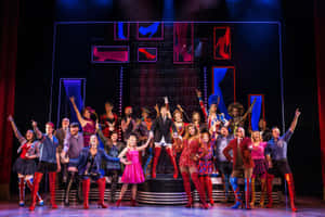 Actors Taking The Stage In A Musical Theatre Performance. Wallpaper