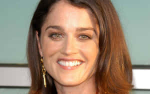 Actress Robin Tunney Smiling During A Photoshoot Wallpaper