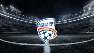 Adelaide United In Action On A Football Field Wallpaper