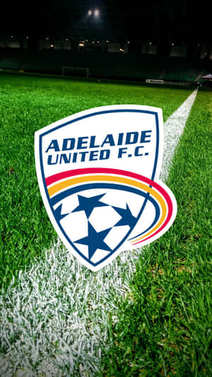 Adelaide United Players Celebrating A Goal In Action Wallpaper