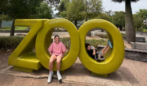 Adelaide Zoo Entrance Signwith Visitors Wallpaper