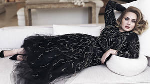 Adele Posing On A Sofa Wallpaper