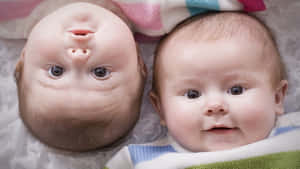 Adorable Baby Smiles And Laughs While Lying On Back Wallpaper