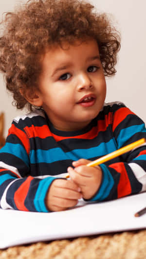 Adorable Boy Drawing With Pencil Wallpaper