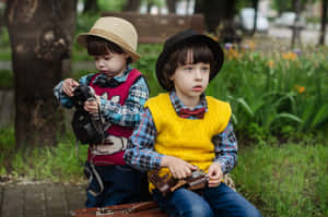 Adorable Children Laughing And Playing Together Outdoors Wallpaper