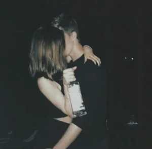 Adorable Couple Sharing A Romantic Moment Together Wallpaper