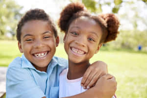 Adorable Kids Playing Together Outdoors Wallpaper