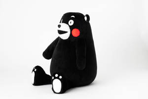 Adorable Kumamon Bear Plushie Sitting Comfortably Wallpaper