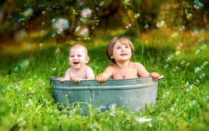 Adorable Siblings Enjoying Nature Together Wallpaper