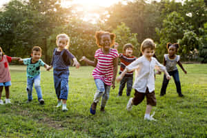 Adorable Smiling Kids Playing In A Park Wallpaper