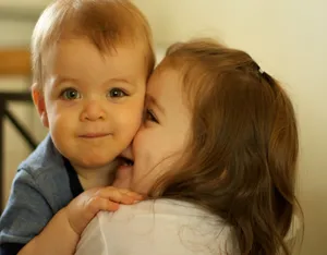 Adorable Toddler In A Yellow Raincoat Smiling Holding An Umbrella Wallpaper