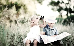 Adorable Toddler Smiling In A Sunny Park Wallpaper