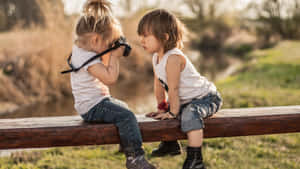 Adorable Toddler Smiling Outdoors In The Park Wallpaper