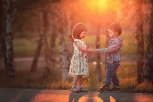 Adorable Toddlers Laughing And Bonding Outdoors Wallpaper