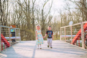 Adorable Toddlers Smiling And Playing Together Wallpaper