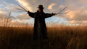 Adorning A Field With Spread-out Scarecrows Wallpaper