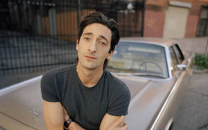 Adrien Brody On A Vintage Car Wallpaper